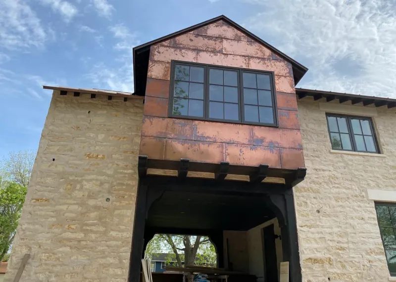 Copper metal panel facade on a stone building for Metal Roof Coating in Pomona